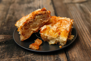 Baklava - homemade pie with walnuts on old wooden table