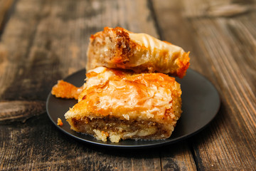 Baklava - homemade pie with walnuts on old wooden table