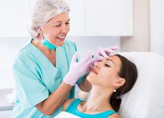 Young woman getting facial injection