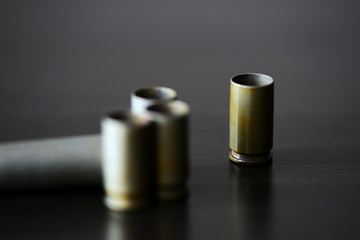 Empty old bullet cartridges on a dark background close up