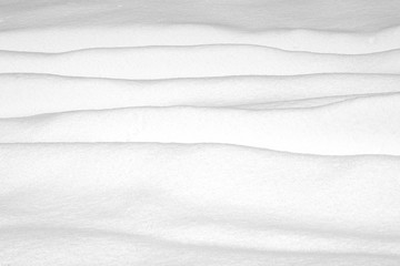 Fototapeta na wymiar Snow drifts and surface as background and texture