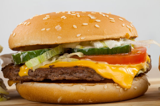 Close up picture of a tasty double cheeseburger with beef, cheddar, lettuce in a sesame bun 