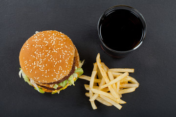 Obraz na płótnie Canvas Delicious junk food: burger, fries, coca-cola
