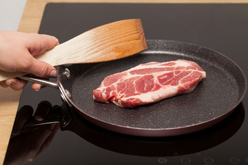 Pork steak in non-stick frying pan