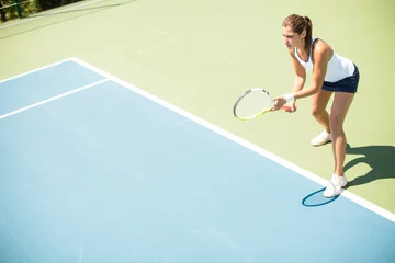 Zelfklevend Fotobehang Young woman playing tennis © BGStock72