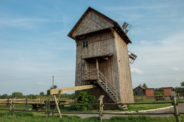 Historic old Polish wooden windmill and blue sky