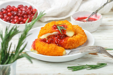 Baked or fried Camembert or brie cheese with cranberry and rosemary sauce. Gourmet Breakfast. Selective focus