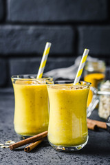 Cinnamon ginger turmeric smoothie on dark background. Selective focus, space for text.
