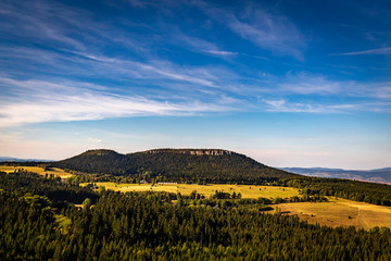 Scenic view with dark blue sky on massif of Table mountains from Fort Karola, near Szczeliniec Wielki in National Park Stolowe Mountains, Sudety, Poland - obrazy, fototapety, plakaty