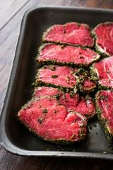 Package of Raw Tenderloin Meat with Herbs and Spices in Plastic Box / Container.