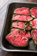 Package of Raw Tenderloin Meat with Herbs and Spices in Plastic Box / Container.