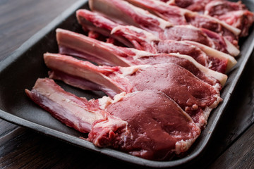 Package of Raw Lamb Chops Meat in Plastic Box / Container.