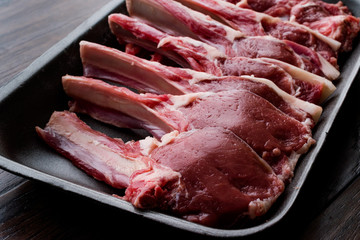 Package of Raw Lamb Chops Meat in Plastic Box / Container.