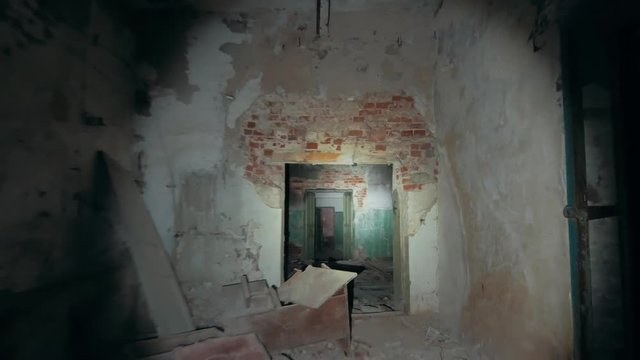 First person view with flashlight in dirty grungy corridors or tunnel in abandoned ruined industrial building, horror escape concept, toned