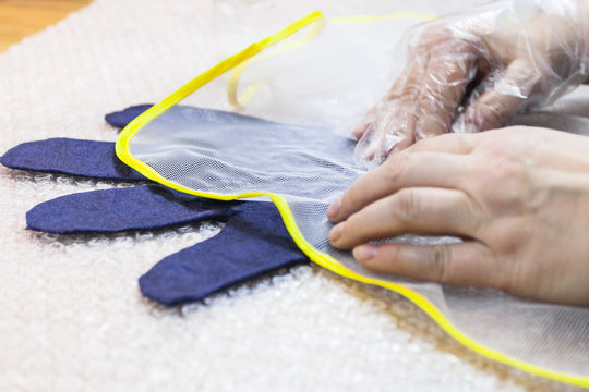 craftsman rubs fibers to glove through mesh