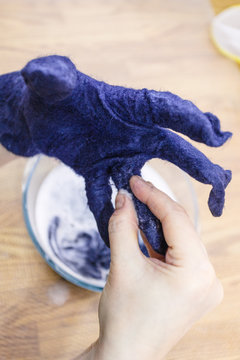 craftsman adjusts size of finger in felted glove