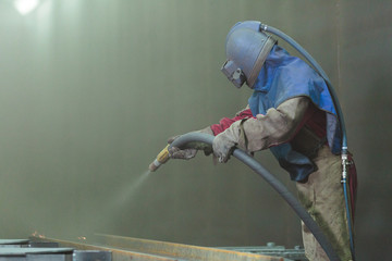 Sandblast. Blasting metal.