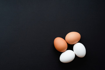 chicken eggs on black background