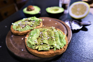 Avocado toast , overhead viewy avocado sandwich on toast bread made with fresh avocado paste on the black background
