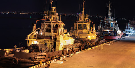 night view of the three tugboats in the cargo port of Odessa, Ukraine
