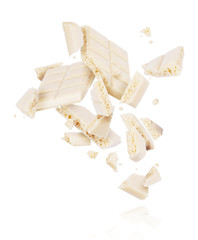 Broken porous white chocolate fall down isolated on white background