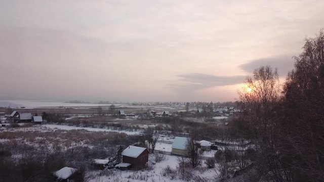 Beautiful winter landscape. Siberian village in the cold. Sunrise. Industrial landscape.
