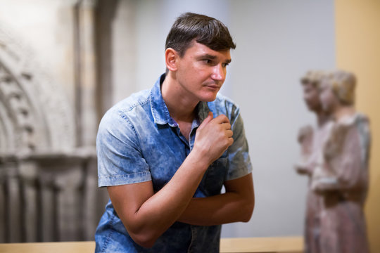Man looking at ancient sculptures