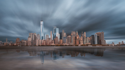 New York City Manhattan downtown skyline in evening with stormy sky