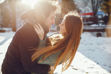 Loving couple walking in a winter park