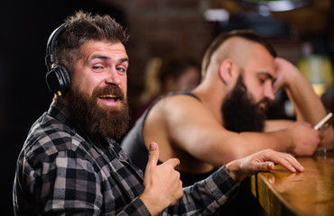 Avoid communication. Escape reality. Friday relaxation in bar. Hipster bearded man spend leisure at...
