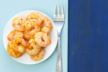 Plate of delicious prawns. Fried prawns with curry, pepper and salt.