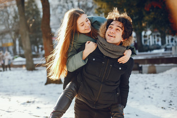 Loving couple walking in a winter park