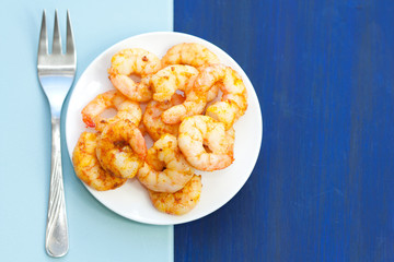 Plate of delicious prawns. Fried prawns with curry, pepper and salt.