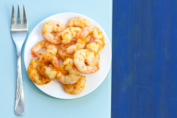 Plate of delicious prawns. Fried prawns with curry, pepper and salt.