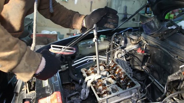 Mechanic repairs the car engine
