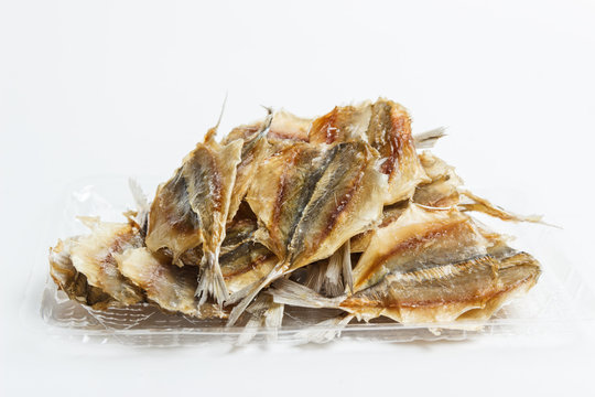 Yellow-striped fish selar on a light background