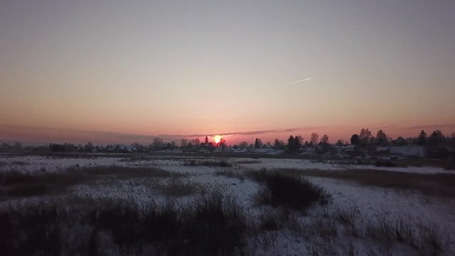 Beautiful winter landscape. Siberian village in the cold. Sunrise. Industrial landscape.
