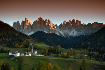 Santa Magdalena Village in Val di Funes with the Odle Dolomites group on the background at the evening. South tyrol, Italy.
