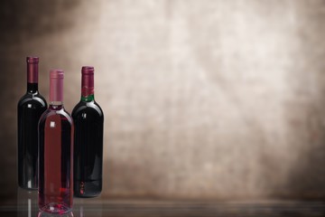 Red wine glass on wooden desk at wall background