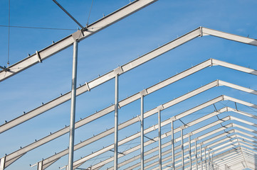 The structure of the building. Steel construction on the background of the winter landscape.