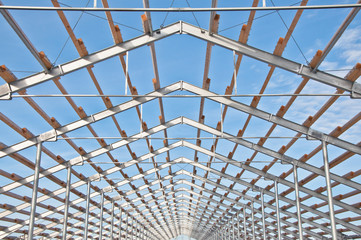The structure of the building. Steel construction on the background of the winter landscape.