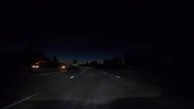 Wet Los Angeles California night freeway driving below route 118 signs near route 405 in the San Fernando Valley. 