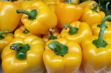 colorful bell peppers on wooden background