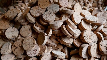 Cork, cork pieces, cork slices, texture, closeup.
The bark of the cork oak was pressed in a factory and punched into small pieces. Ideal for further processing for various products made of cork
