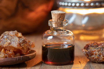 Fototapeta na wymiar A bottle of myrrh essential oil with myrrh resin