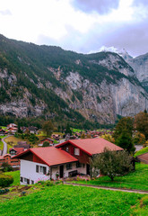 Fototapeta na wymiar Wooden houses in the Swiss Alps on a cloudy day