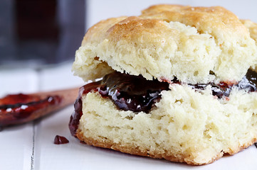 Buttermilk southern biscuit with raspberry or strawberry jam or jelly. Extreme shallow depth of...