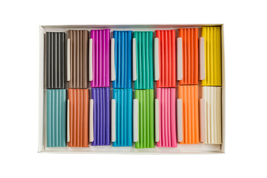 Modeling clay. Multicolored plasticine bars in a box isolated on white background.