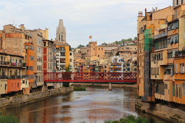 Colorful houses and Eiffel brige on river Onyar in Girona