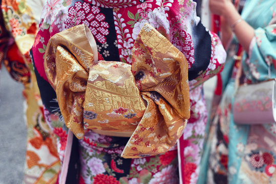 Midsection of women in kimono standing outdoors